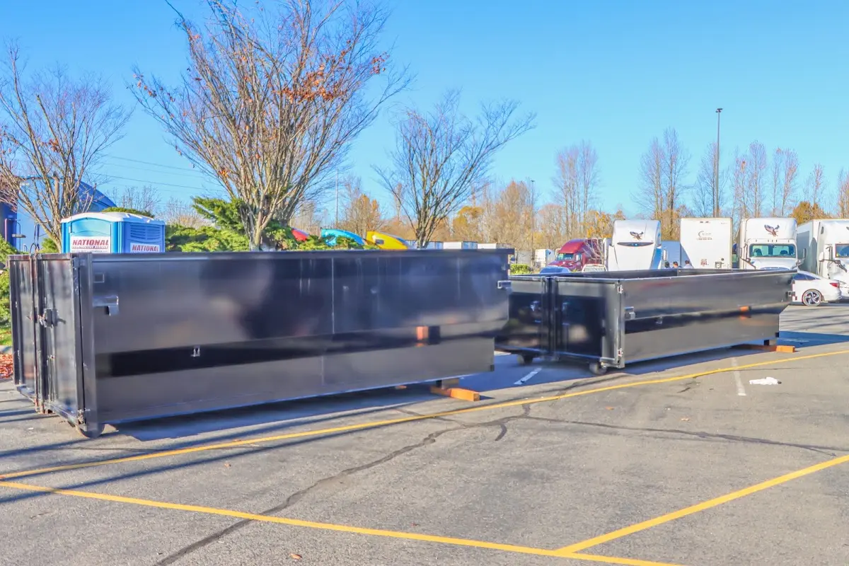 Professional dumpster rental service with roll-off container on residential driveway in Oviedo